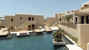 A rooftop pool area with multiple lounge chairs and a small water feature. - The Key  (Naxos)