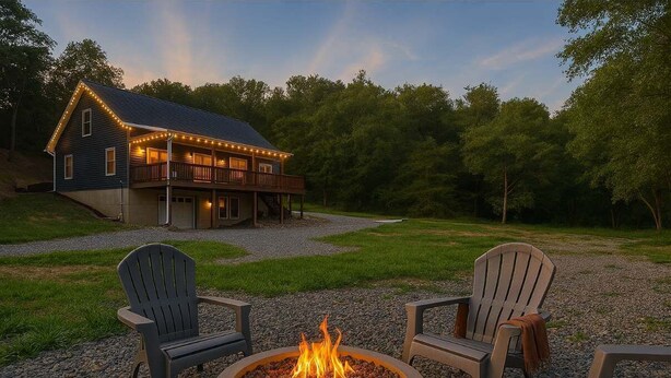 A house with a fire pit in the foreground and a deck with string lights in the background. - The Haven at Turkey Run • Hot Tub, Fire Pit, Games (Strasburg)