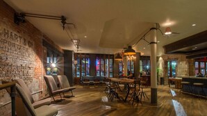 A restaurant with a brick wall, wooden flooring, and a bar area. - Incredible Location, Steps from French Quarter (New Orleans)