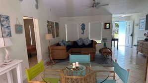 A spacious living area with a sofa, chairs, a dining table, and a ceiling fan. - Port St Lucie 3BD -2B (Port Saint Lucie)