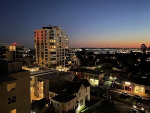 A multi-story building with illuminated windows, surrounded by other buildings and a street. - San Diego | Balboa Park Escape | Hot Tub & Rooftop Deck (San Diego)