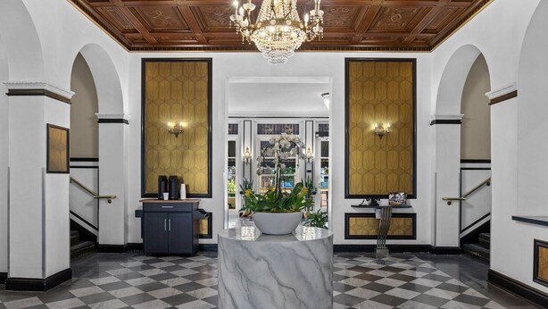 A lobby with a marble column, checkered floor, chandeliers, and a view into a room with a large window. - San Diego | San Diego Zoo Trip | Hot Tub & Rooftop Deck (San Diego)