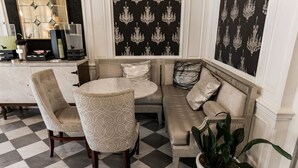 A room with a checkered floor, a round table, two chairs, a sofa, and a potted plant. - San Diego | San Diego Park Trip | Hot Tub & Rooftop Deck (San Diego)