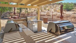 An outdoor patio with a grill, a table, and a covered seating area. - WorldMark South Mountain Preserve - 3 Bedroom (Phoenix)