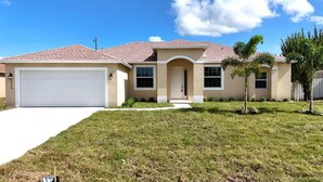 A single-story house with a garage, a front porch, and a well-maintained lawn.