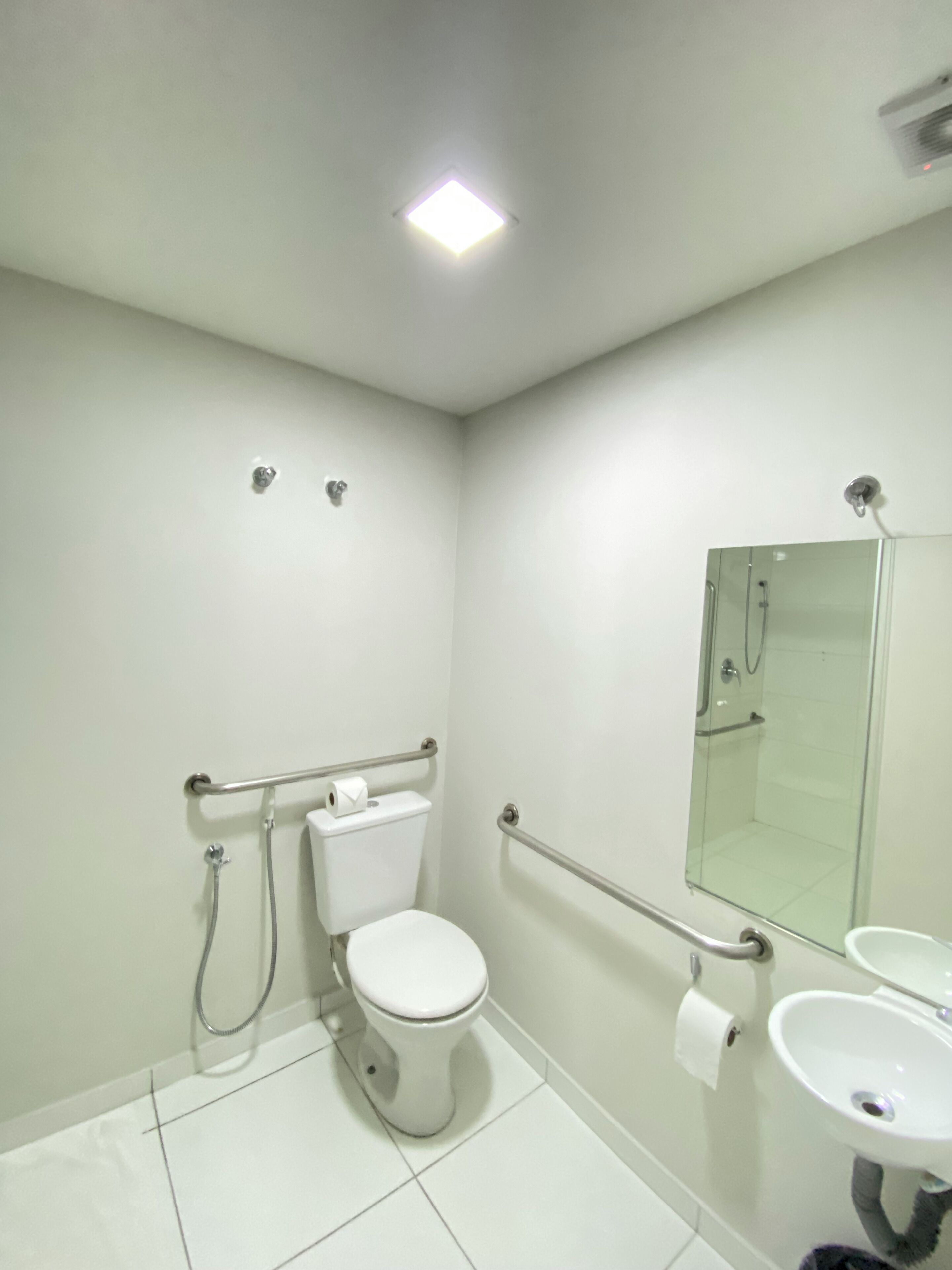 A modern bathroom with a toilet, bidet, and sink.