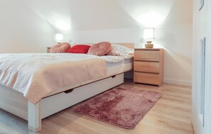 Cozy retreat with a single bed, two bedside tables, and a nightstand.