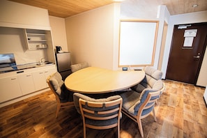 Cozy room with a round dining table and cabinet, perfect for a relaxing stay.