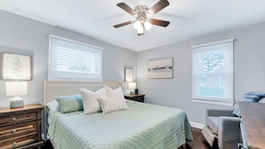 A bedroom with a bed, nightstands, a desk, and a ceiling fan. - 4BR Norfolk Home • Game Room • Dog Friendly (Norfolk)