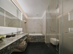 A modern bathroom with a marble vanity, a freestanding bathtub, and a glass-enclosed shower. - WEZO HOTEL CHENGDU (Chengdu)