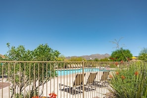 A pool area with lounge chairs and a view of mountains in the background. - Oro Valley | Couples Desert Escape | Pool + Hot Tub (Oro Valley)