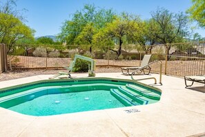 A swimming pool with steps, surrounded by a fence, and equipped with lounge chairs. - Oro Valley | Couples Desert Escape | Pool + Hot Tub (Oro Valley)
