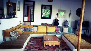 A cozy living room with a sectional sofa, a coffee table, and a patterned rug.
