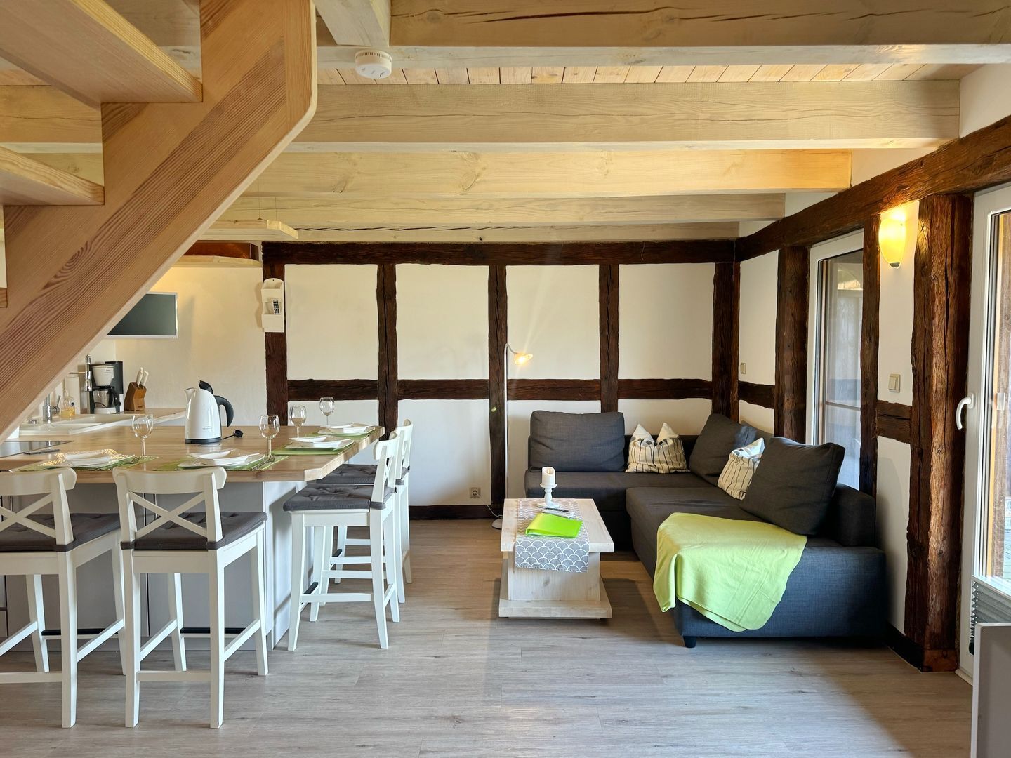 A cozy room with a dining area, a sofa, and a coffee table.
