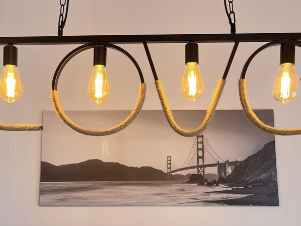 A wall-mounted light fixture with five exposed bulbs, each encased in a circular, textured ring. - Complete rural house for 6 people in Pedralba (Valencia). (Pedralba)
