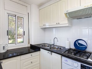 Fridge, microwave, cookware/dishes/utensils, dining tables