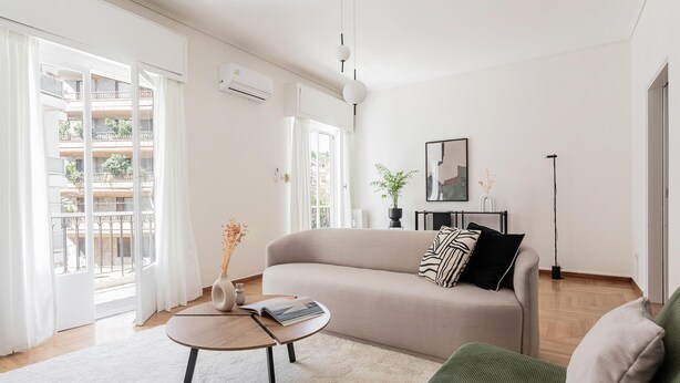 A modern living room with a sofa, a coffee table, and a floor lamp. - Acropolis Sunlight 2BR Aparment (Athina)