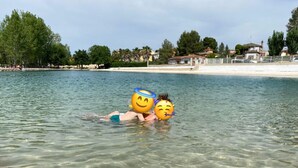 A beach scene with clear water and a person lying on the sand. - Casa the Dutchman,  totally off-grid,on a private plot of 10.000m2 (Navarres)