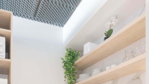 A modern kitchen with white cabinets, a marble backsplash, and a coffee maker on the counter. - MOT Rentals + Madero Azopardo 'C' Lux 1 Bd (Puerto Madero)