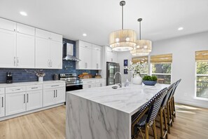 Fridge, microwave, oven, stovetop - Discover modern riverfront luxury at The White House. Enjoy a sleek designer kitchen, a tranquil master suite, and an expansive deck with breathtaking views of the Guadalupe River. Experience the perfect blend of hotel-quality service and the privacy (New Braunfels)