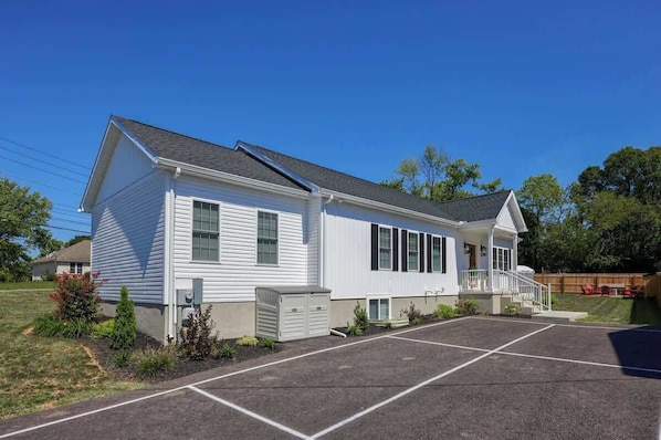 A single-story house with a front porch, a garage, and a driveway.
