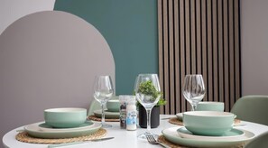 A dining table set with bowls, wine glasses, and a small potted plant. - The Lampton - Modern - Gibside - Smart Tv - WIFI (County Durham)
