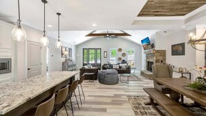 A spacious living area with a kitchen, dining table, and seating arrangements. - Jocassee Retreat - .5 miles from Lake Jocassee (Salem)