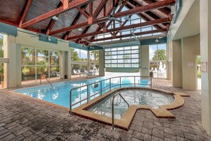 Swim and unwind in our spacious pool area with a hot tub, offering a serene view of the surrounding landscape.