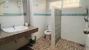 A bathroom with a sink, toilet, and shower area. - Minotel Patong (Patong)