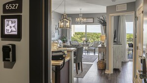 A modern interior with a dining area, kitchen, and a balcony with a view. - Luau *5th Floor* Condo, 1 bedroom plus bunk beds at Sandestin Golf & Beach Resort! (Miramar Beach)