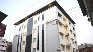 A modern hotel building with a prominent sign reading "HOTEL KARISH."