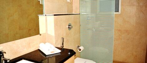 A bathroom with a sink, toilet, and shower.