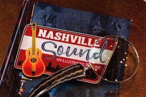 A book titled 'Nashville Sound' with a guitar illustration, placed on a textured surface.