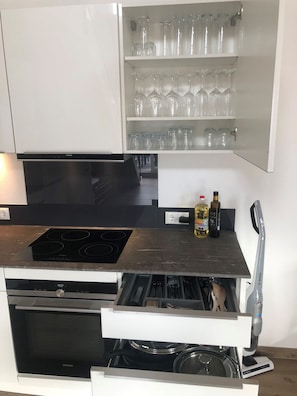 A kitchen with a Siemens dishwasher, a Siemens oven, a Siemens microwave, a Siemens induction cooktop, and a Siemens coffee machine.