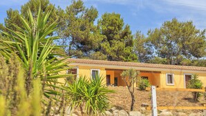 A yellow building with a tiled roof, surrounded by trees and plants. - Li Scalitti Residence with swimming-pool (Badesi)