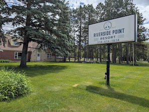 A sign for Riverside Point Resort with a contact number. - Brick House on the River at Riverside Point Resort (Park Rapids)