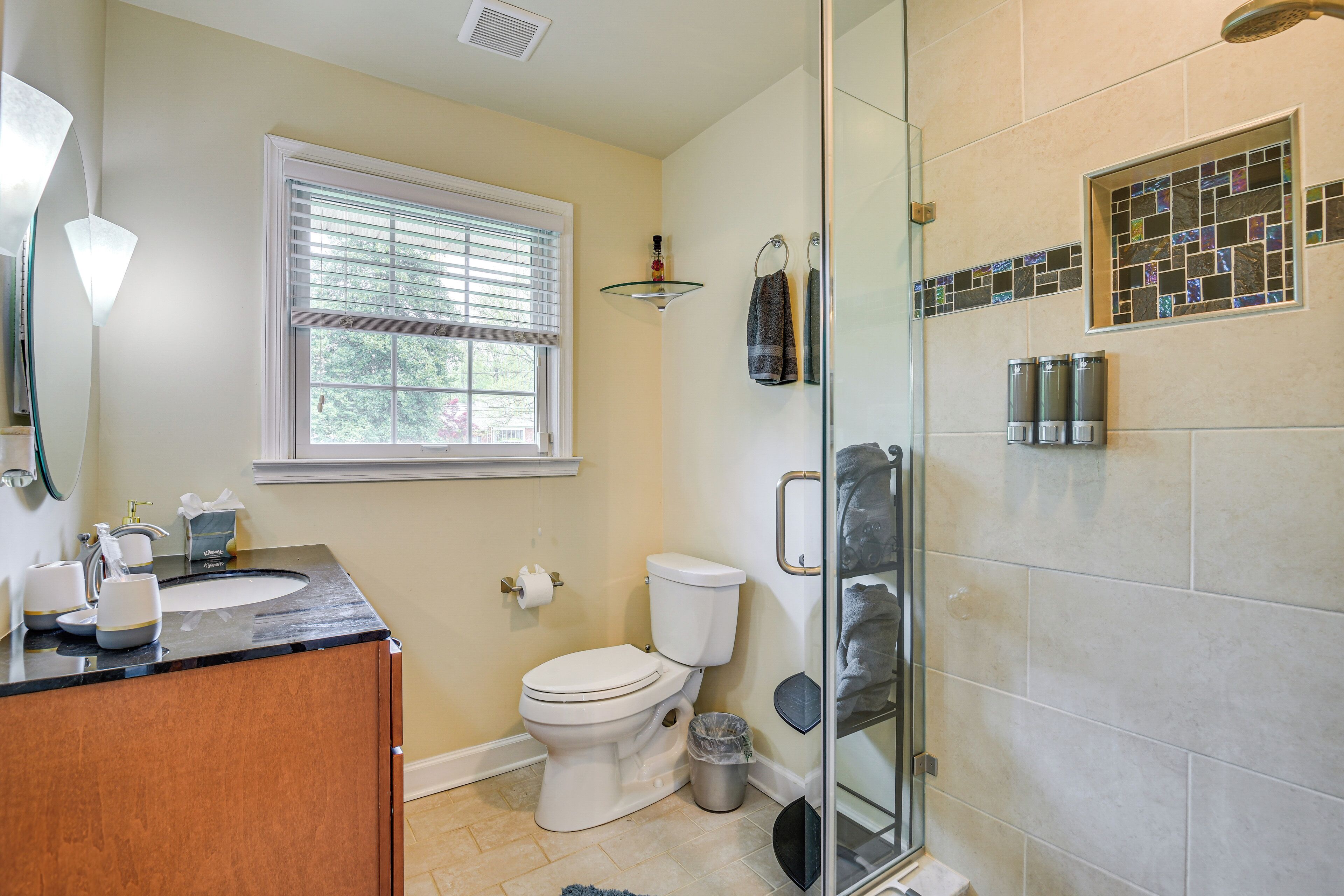 A bathroom with a toilet, sink, and shower.