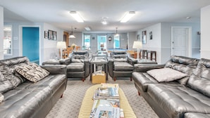 A spacious living room with leather sofas, a coffee table with magazines, and a bright, well-lit ceiling with recessed lighting. - Livin Wells' Retreat, 2 Mi to Drakes Island Beach (Wells)