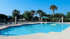 A swimming pool with a surrounding deck, palm trees, and a playground in the background. - Lexington Family Home ~ 9 Mi to Lake Murray! (Lexington)