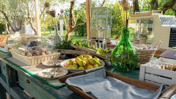 A buffet table with various food items and a green bottle. - BIO AGRITURISMO SALOS (Otranto)