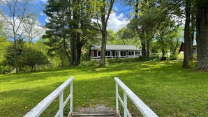 A wooden staircase leading to a house surrounded by trees. - Big Pines at the Lake -  waterfront  - swimming, fishing, boating (Cooperstown)