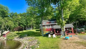 A lakeside cabin with a dock, a small shed, and a playground area. - Big Pines at the Lake -  waterfront  - swimming, fishing, boating (Cooperstown)