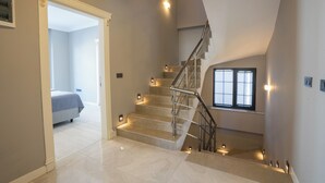 A modern staircase with a metal railing, leading to a bedroom with a bed and a window. - Villa Tutar Icmeler Daily Weekly Rentals (Marmaris)