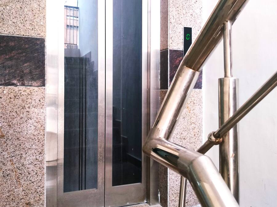 An elevator with a sign stating "Only 3 person allowed".
