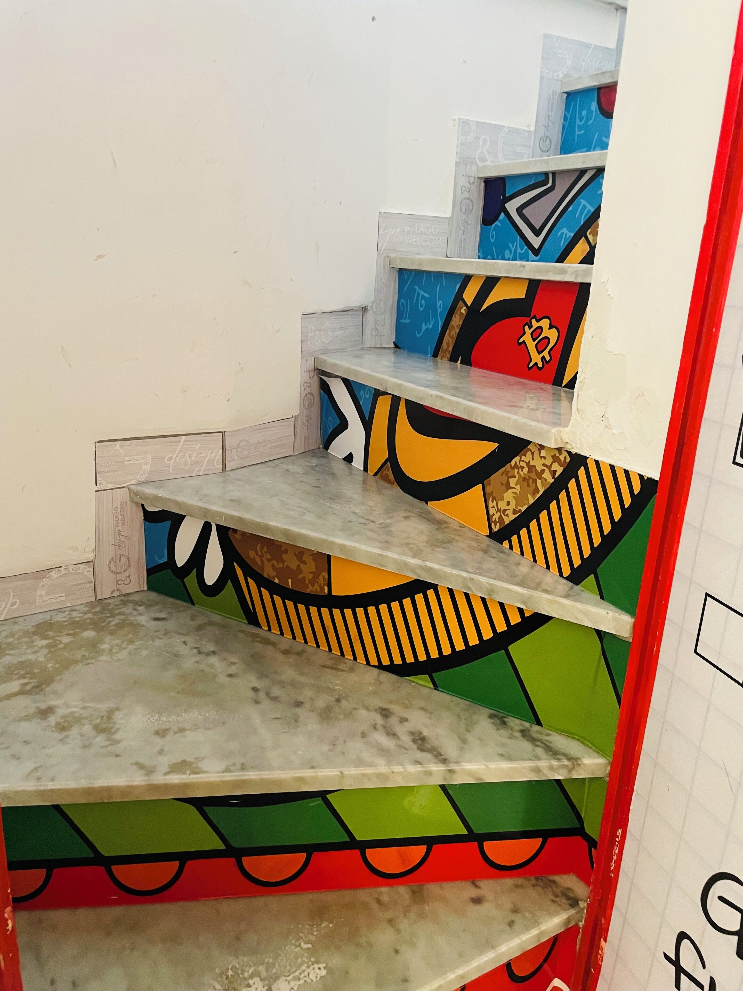 A staircase with colorful, graffiti-style designs on the steps and walls.