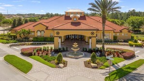A yellow building with a red-tiled roof, a central fountain, and landscaped gardens. - BV310MB - Disney & Universal heroes - 16 guests (Kissimmee)