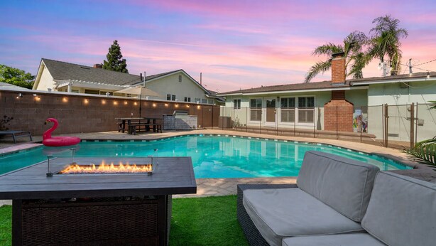 A backyard with a swimming pool, a fire pit, and outdoor furniture. - Ladoga's Hideway, Gorgeous Pool, Game Room, Fire Pit, Private Backyard,BBQ Grill (Long Beach)