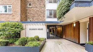 A modern building entrance with a sign reading "KILMUIR HOUSE".