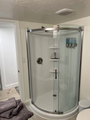 Een douche, handdoeken, zeep, shampoo