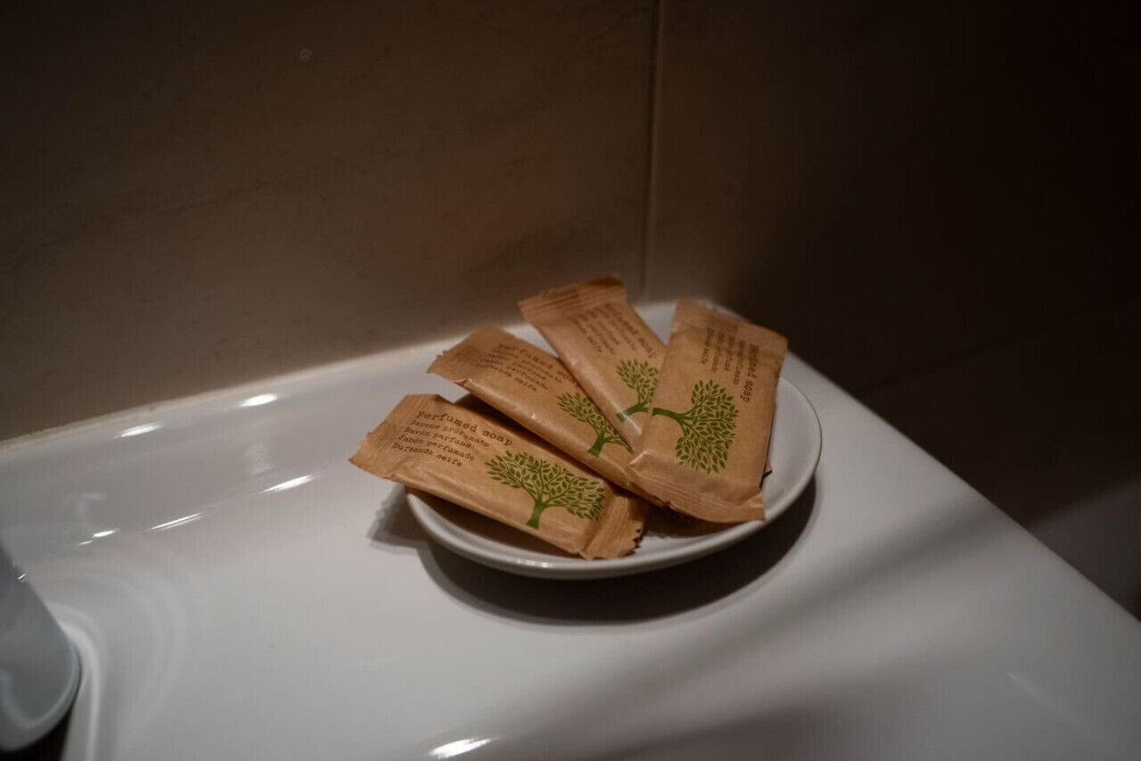 A bowl of packaged items on a white surface.